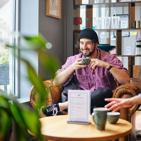 Student drinking in coffee shop