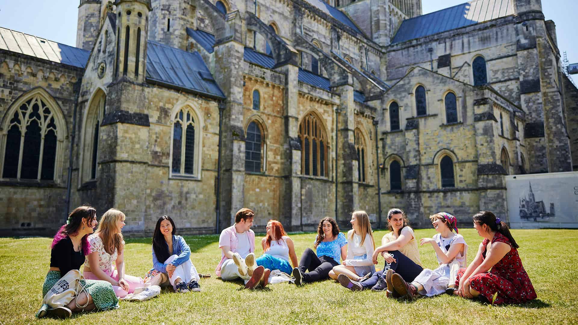 25 Students At Cathedral (43) Students sitting outside Chichester cathedral
