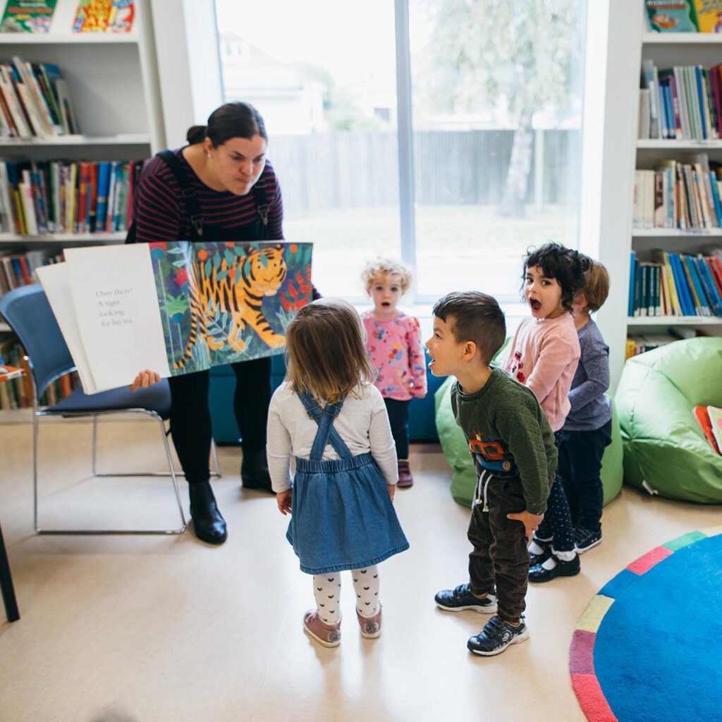 Early Years student working with a number of young children in the Classroom Resources library