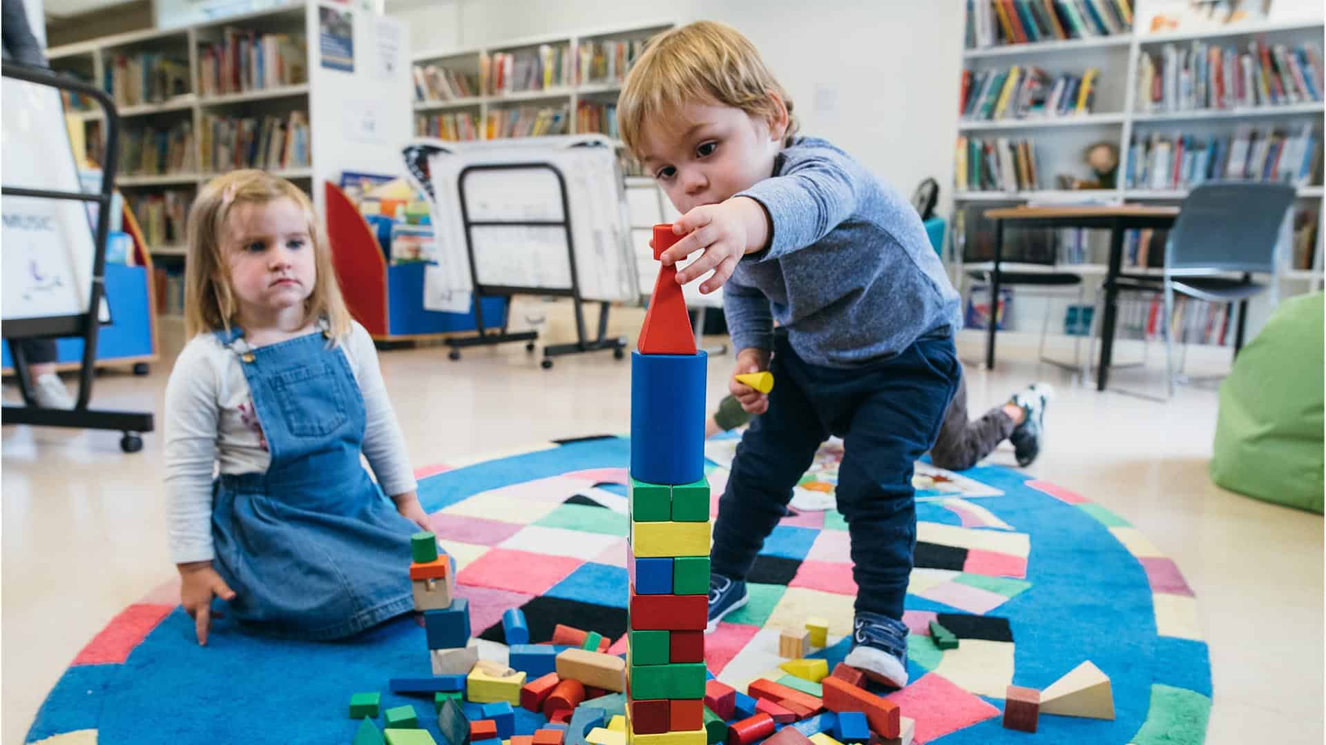 children playing together with building blocks