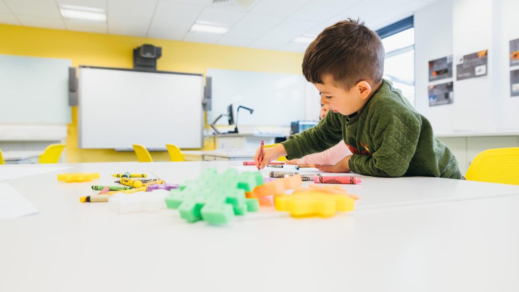 Two early years pupils playing at a table