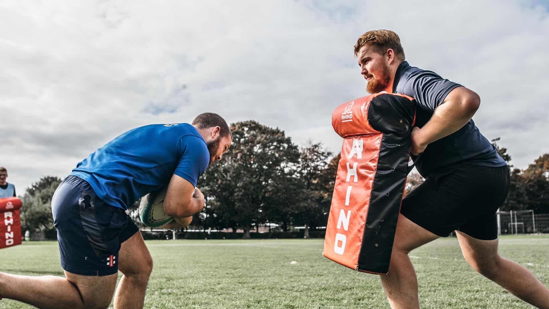 Sport students practising rugby tackling on a tackle bag