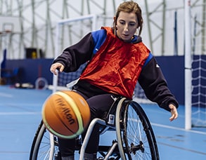 sports student in a wheelchair playing basketball