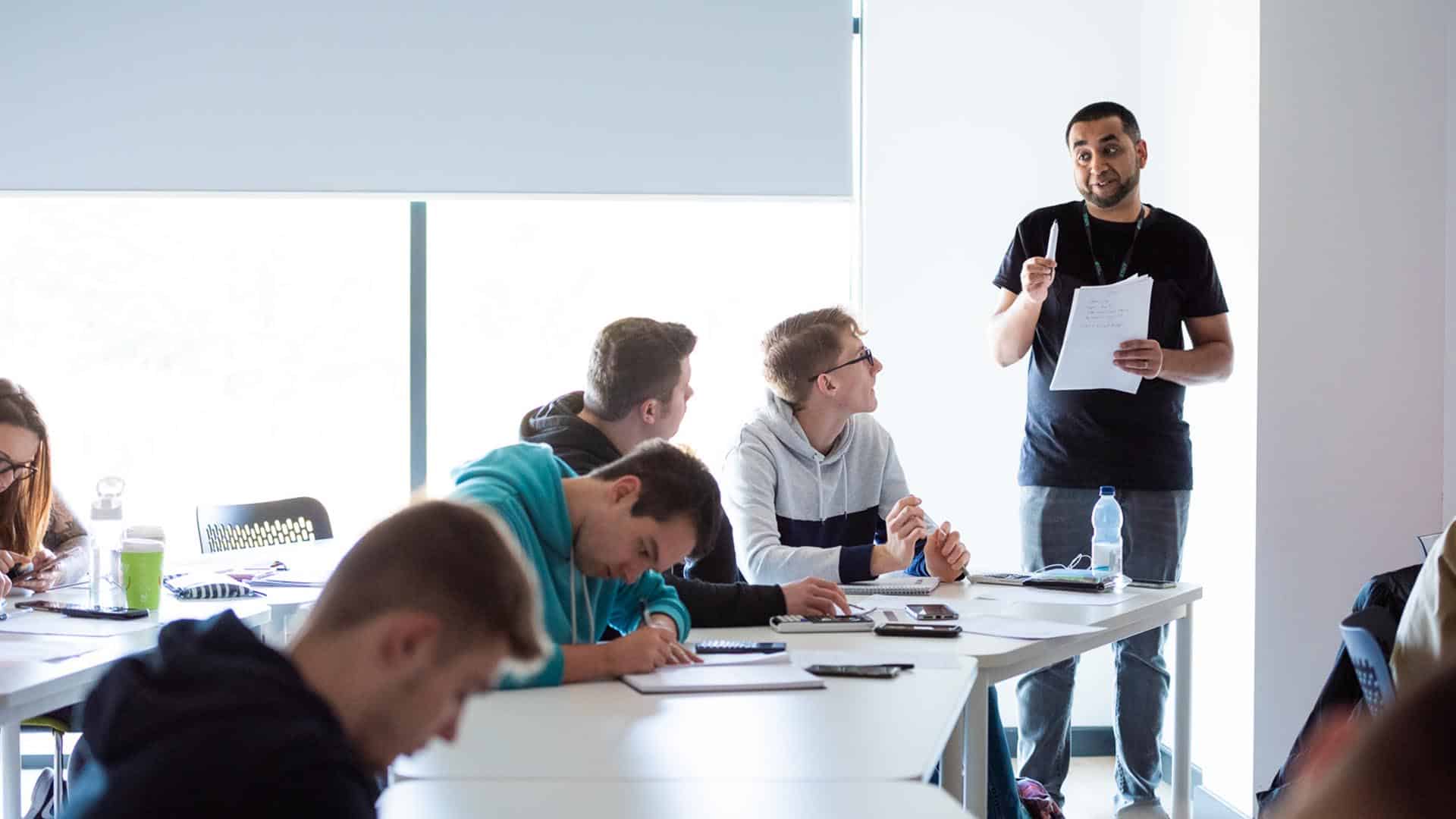 teacher talking to university students