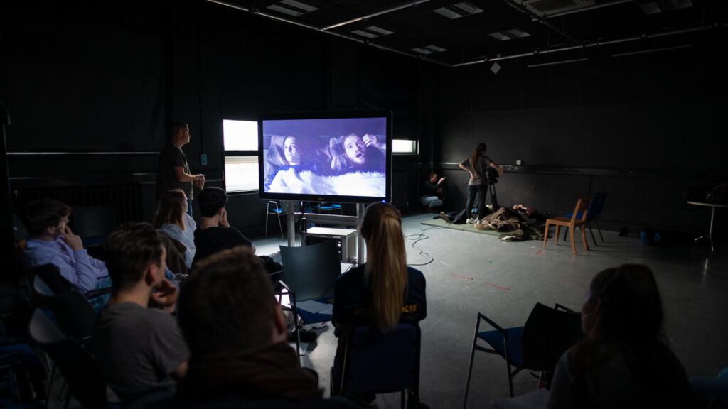 Students using film equipment and editing software