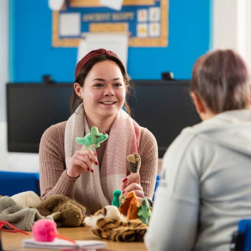 Qualify to teach A teaching student learning to use small toys to facilitate better learning for young children