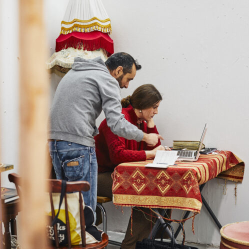 lecturer helping student with art work