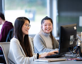 two students looking at a computer in the LRC