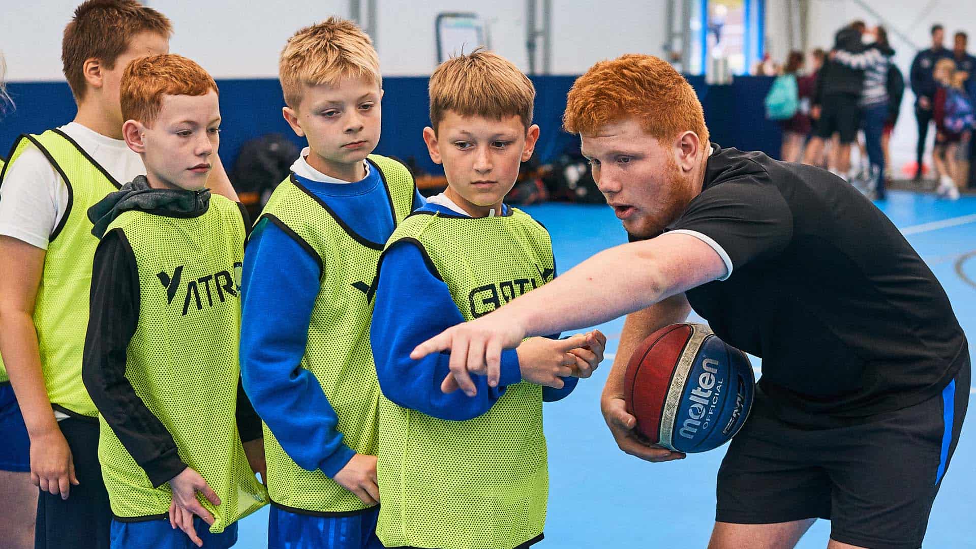 Physical Education student coaching some primary school pupils
