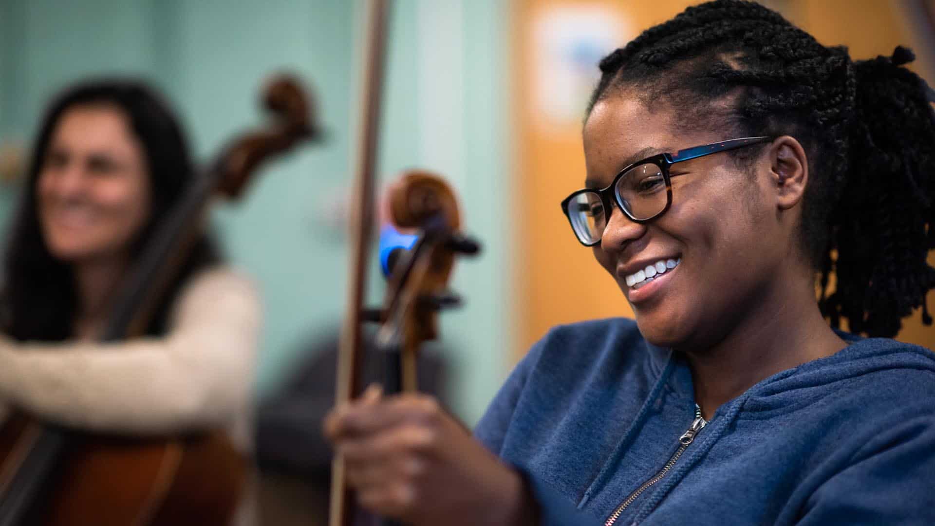 violinist smiling in rehearsal