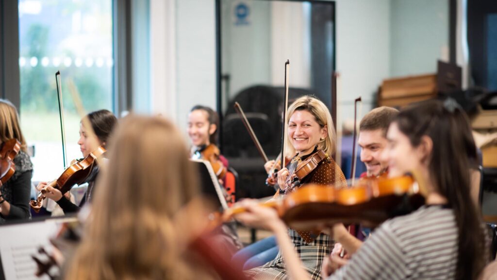 Students smiling in rehearsal