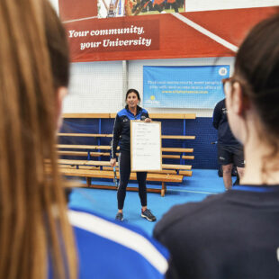 sports teacher delivering a lesson in sports dome