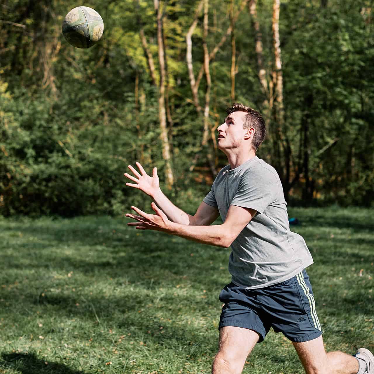 Student catching rugby ball