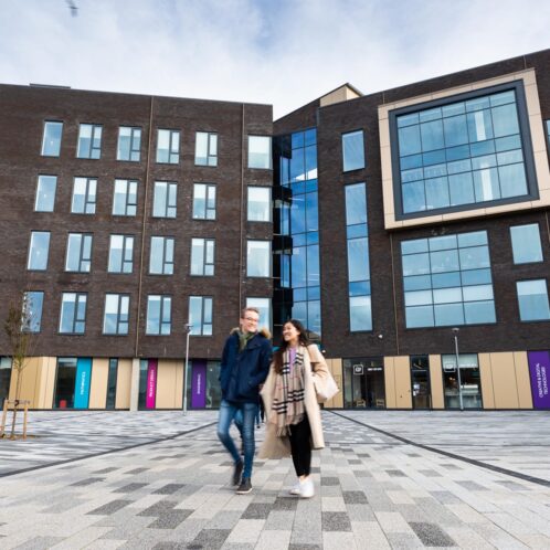 two students walking outside Tech Park