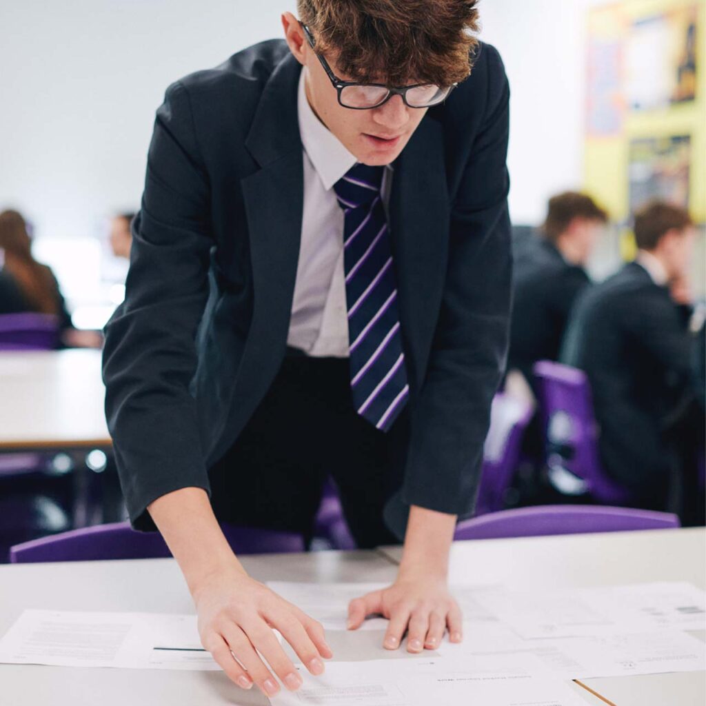 Secondary school pupil completing a maths worksheet