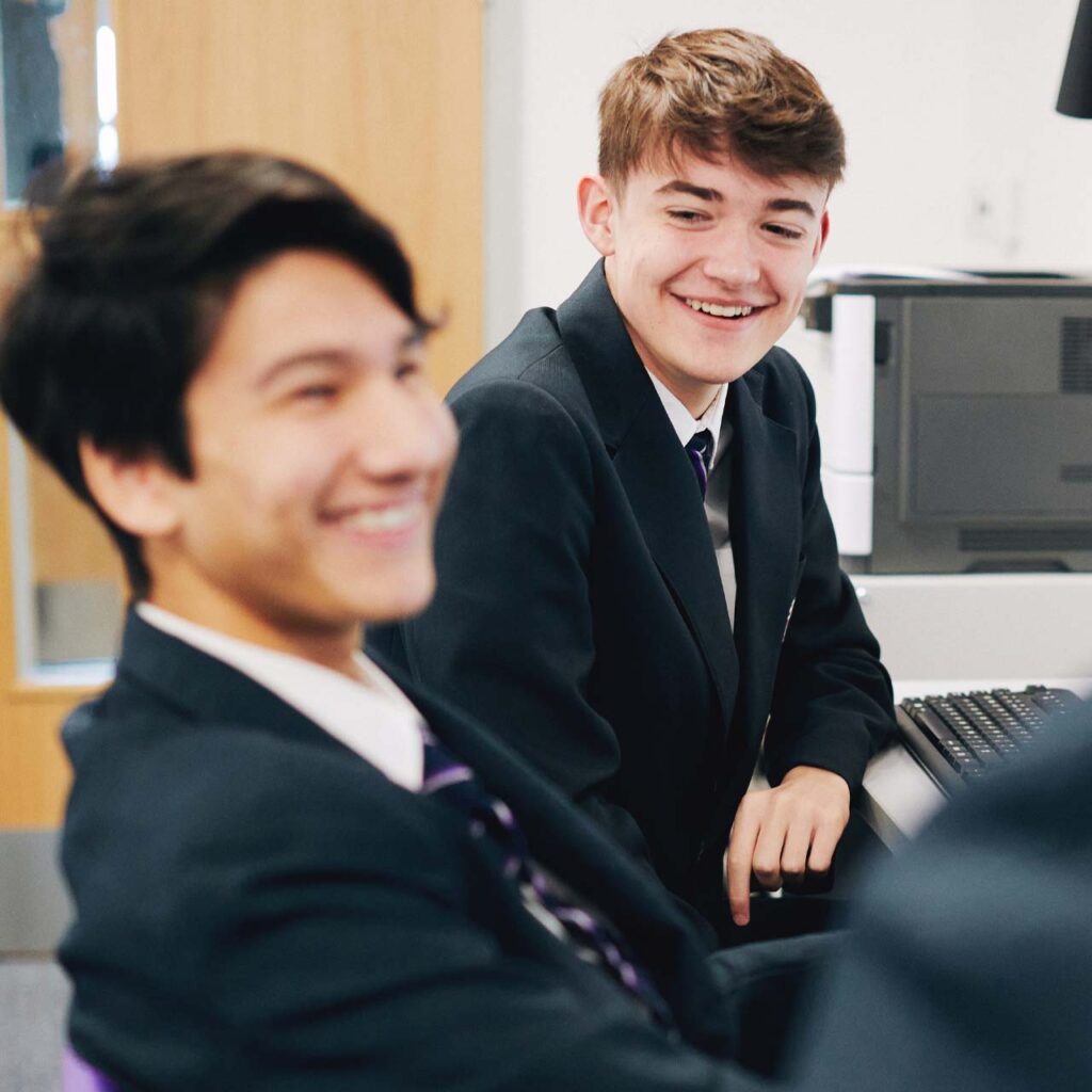 Secondary modern foreign language pupils laughing in a classroom