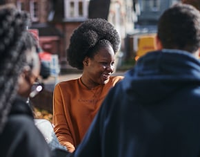 female student laughing with friends outside