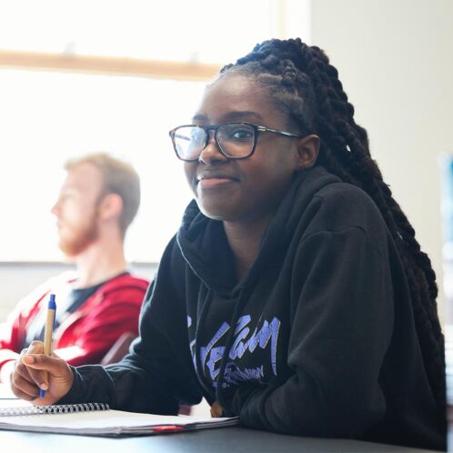 Student in class with a writing pad