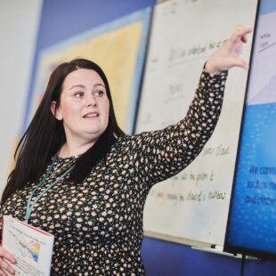 Teaching student leading a primary school class