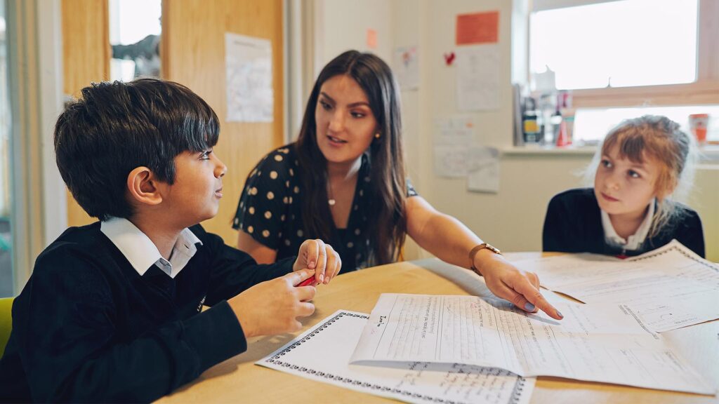 teacher talking to primary students