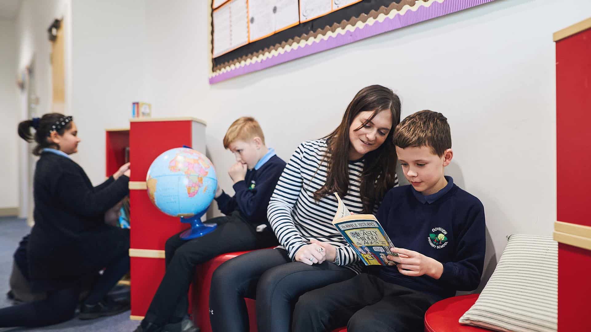 teacher reading book with student