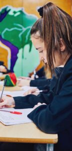 Primary school pupil writing