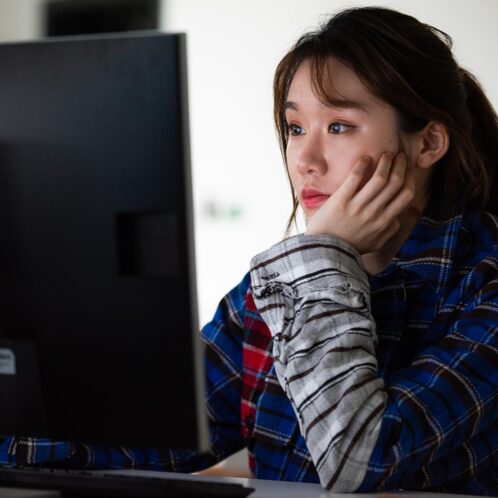 Business student on computer in seminar