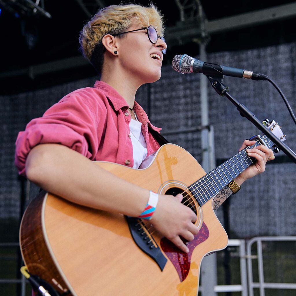 Student performing with guitar