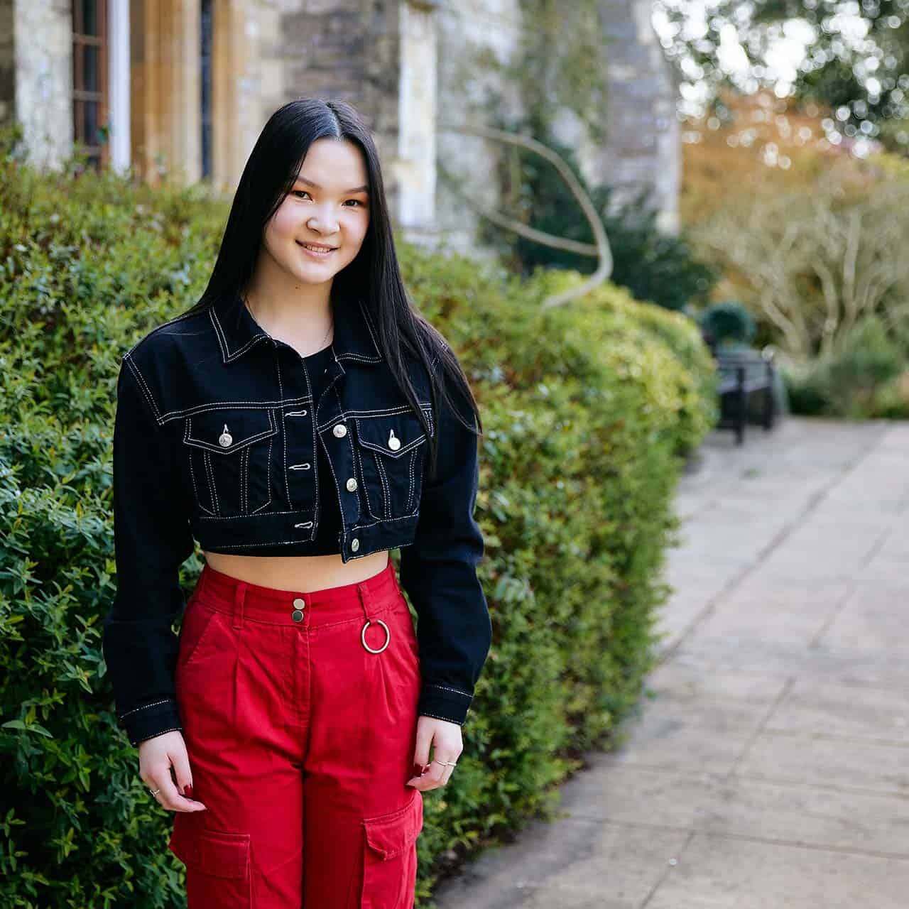 Smiling student by cloisters