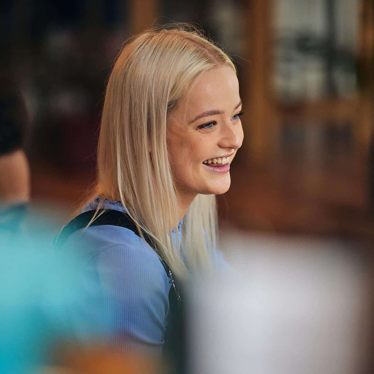 Student smiling in a cafe