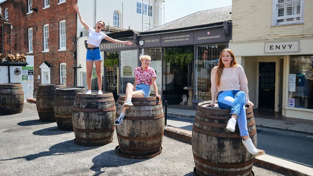 21 Students Arundel Town 1980 X 1080 4 students posing on barrels in arundel town