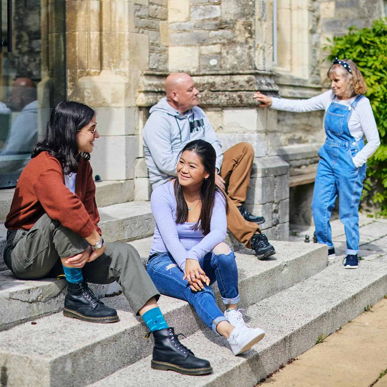 Students sat on steps outside Cloisters