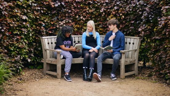 students reading books in the park