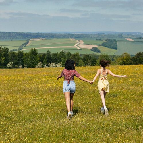 21 Students Chichester Goodwood Trundle 1280 X 1280 27 two students walking on field holding hands