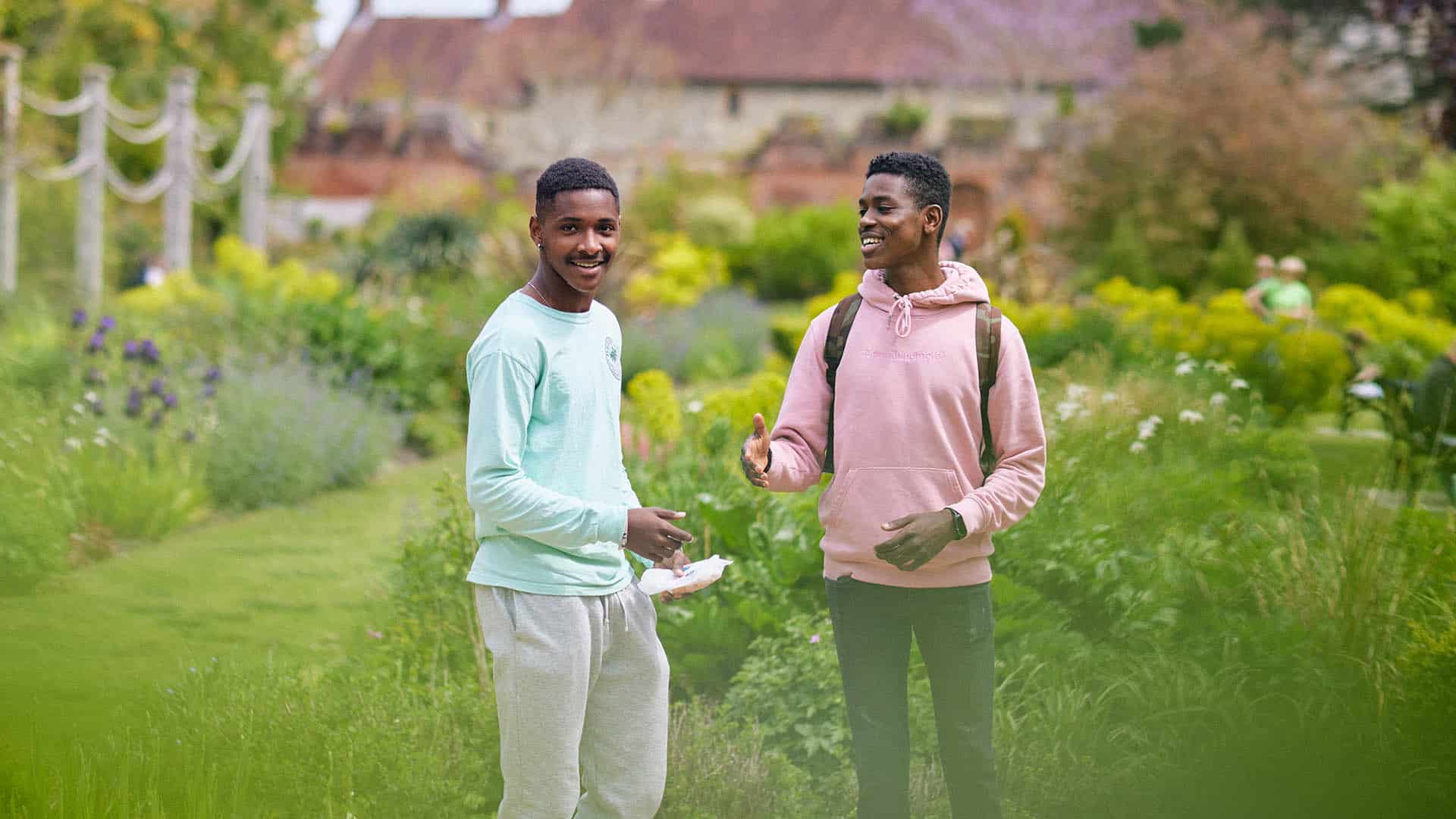 two students laughing in local park