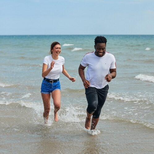 students running in the sea