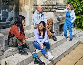 group of students sitting outside Cloisters