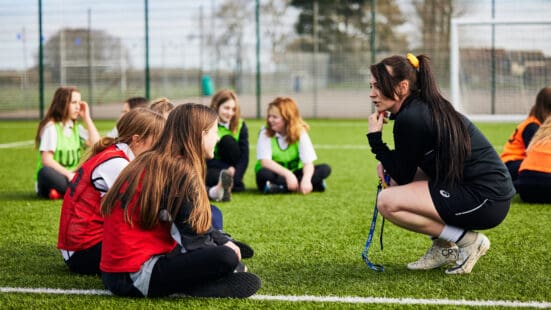 student teaching a group of children sport