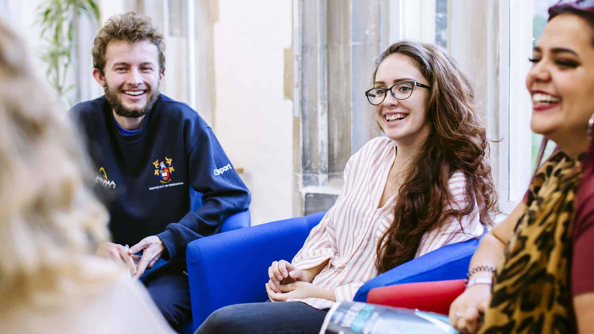 Close Community Students smiling and chatting in one of our communal learning areas