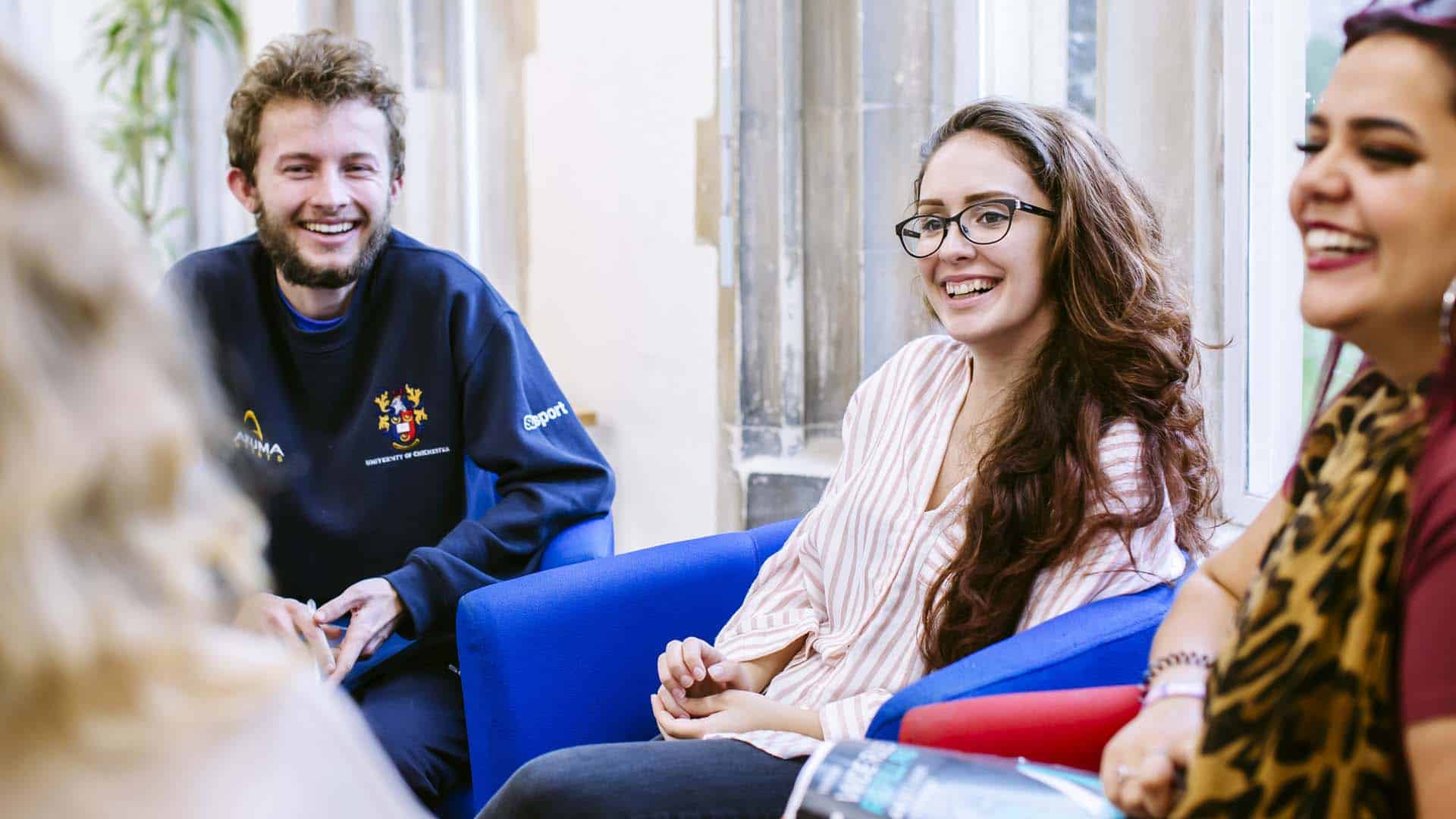 Students smiling and chatting in one of our communal learning areas