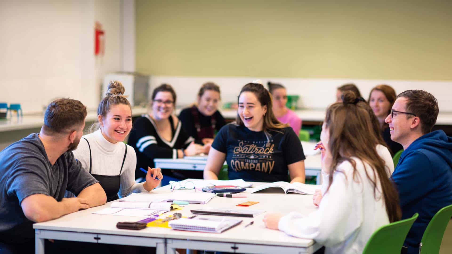 Students learning and laughing in a classroom