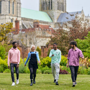 Four students walking towards the camera looking at each other