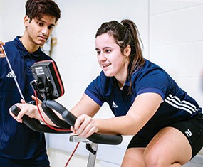 Student cycling on research tracking bike