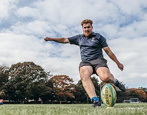 rugby player kicking a rugby ball