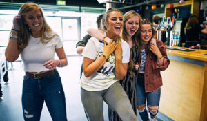 Students laughing at a bar