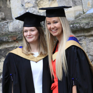 Two postgraduate students at graduation