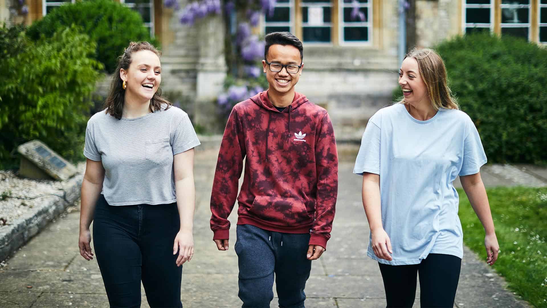 three students walking through Cloisters