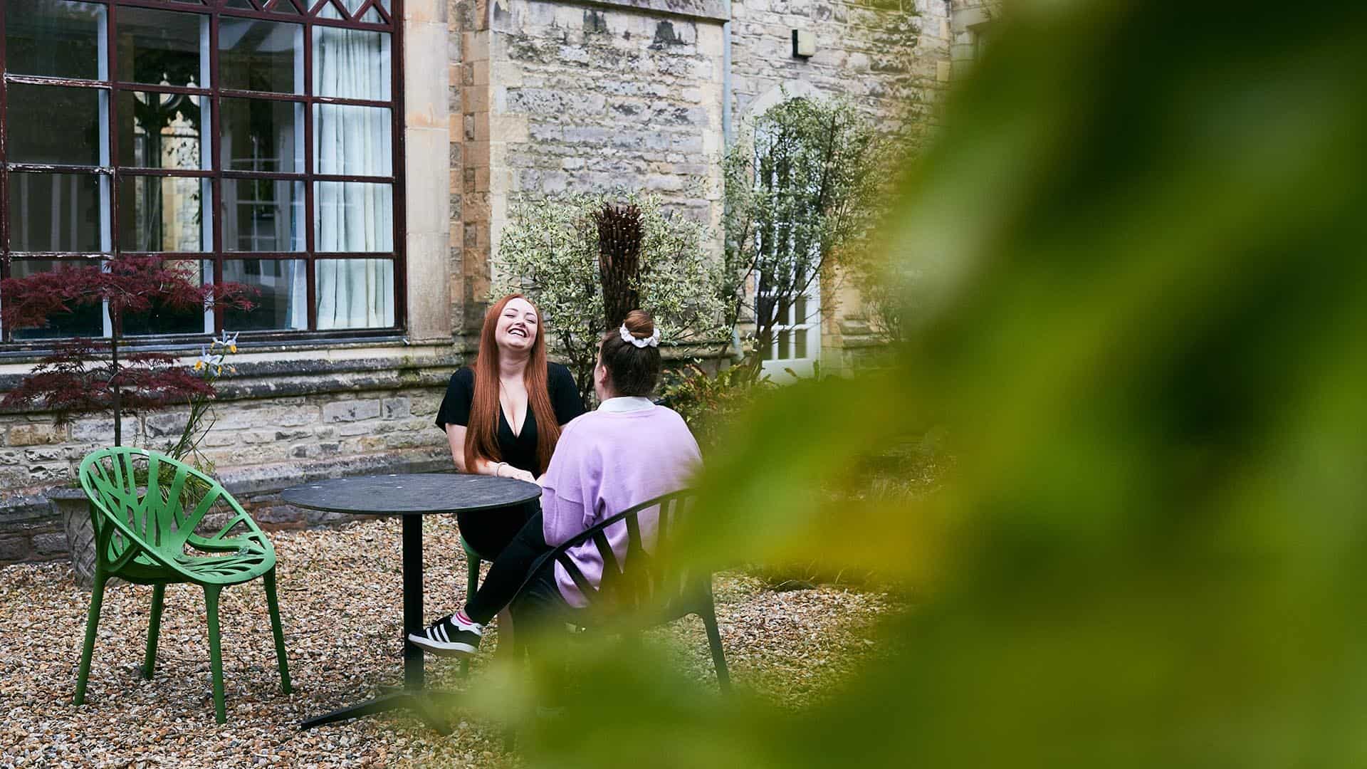 Students sat at table outside Cloisters