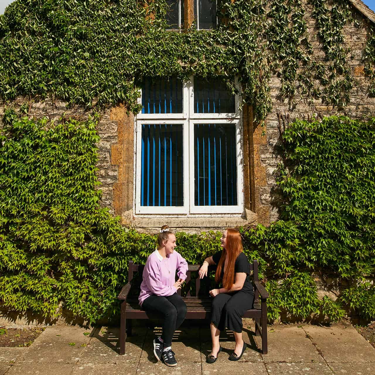 Students sat on bench by window