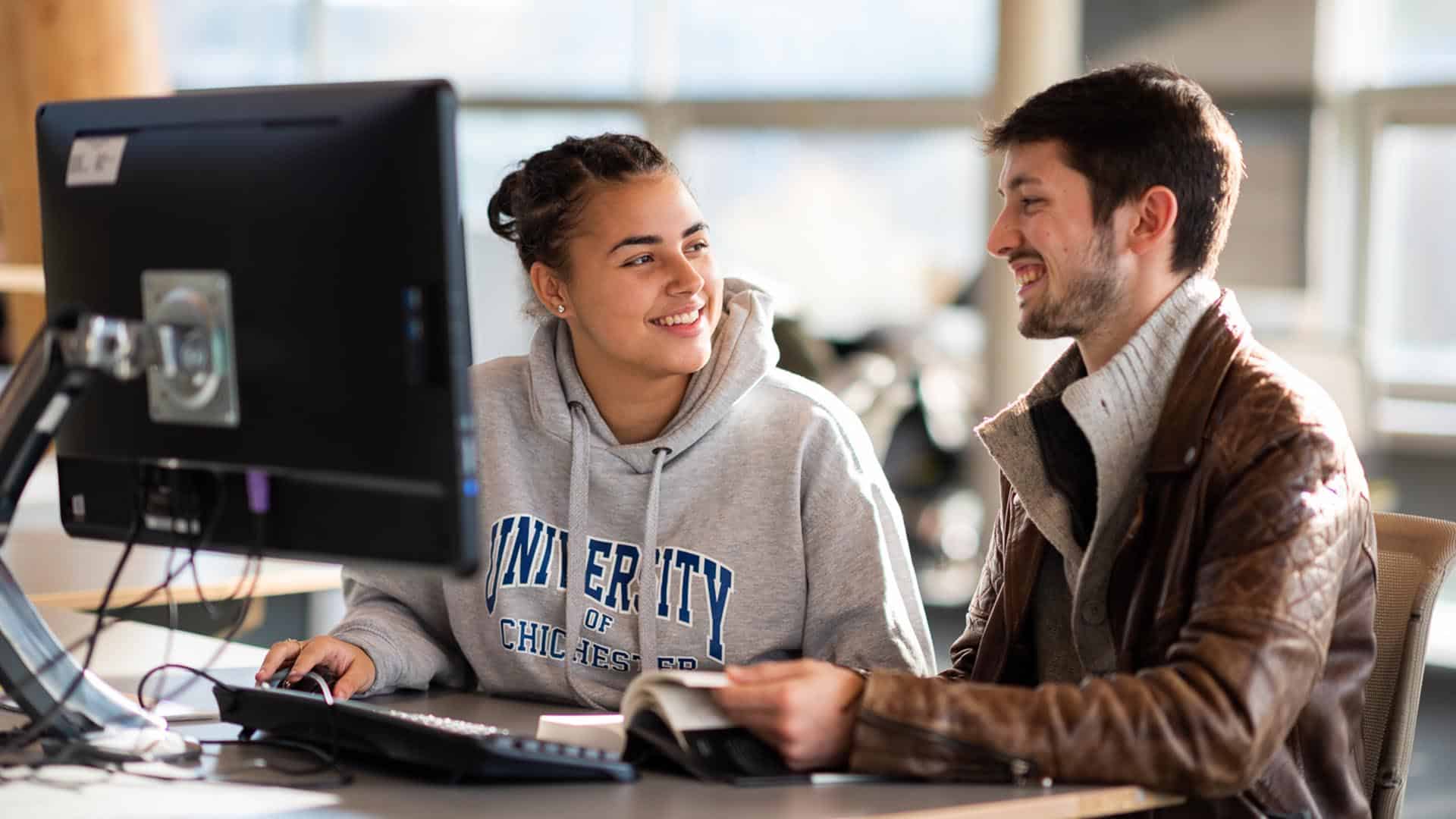 two students working at a computer in LRC